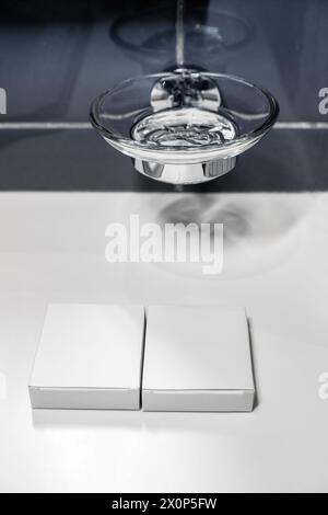 Small packages, boxes for soap or hygiene products with space for text or label against the background of a soap dish in the bathroom. Stock Photo