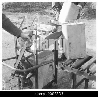 PHOTOGRAPHS TAKEN AT A MOBILE PETROL FILLING CENTRE R.A.S.C. - Showing Rotary Pump on washing machine being operated, with can in position over spray nozzle. Photographic negative , British Army Stock Photo