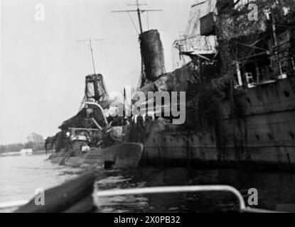 THE NAVY TAKES OVER AT KIEL. 6 TO 12 MAY 1945, THE GERMAN NAVAL BASE AT KIEL AFTER THE ROYAL NAVY HAD TAKEN IT OVER. - The EMDEN, target for RAF bombs and still heavily camouflaged, lying in the dock with a U-boat alongside Stock Photo