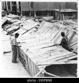 AMERICAN LORRIES ARRIVE IN THE MIDDLE EAST - Empty crates are broken up and the wood is used for a variety of purposes. Photographic negative , British Army Stock Photo