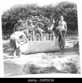 INVASION OF ITALY 'ITS AN ENGINEERS' WAR' - The matting is laid carefully, as its placing greatly influences the life of the finished road, it must be laid level and taut to do its job properly. Photographic negative , British Army Stock Photo