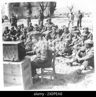 EIGHTH ARMY : THE GURKHAS - The Gurkhas are keen listeners to Indian programmes from the 8th Army Radio Station. They do not appreciate Western musical programmes. At the set is a Gurkha officer, Jemadue Jitbahadur Gurung of Nepal. Photographic negative , British Army Stock Photo