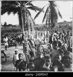 BRITISH OVERSEAS AIRWAYS TRAVERSE AFRICAN CONTINENT - For story see CH.14071 Picture (issued 1944) shows - A village crowd watches the arrival on the shore of passengers and crew from a BOAC Empire flyingboat making a night halt on the Congo River at Stanleyville, in Central Africa. Photographic negative , Royal Air Force Stock Photo
