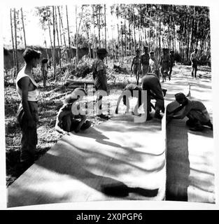 INVASION OF ITALY 'ITS AN ENGINEERS' WAR' - The matting is laid carefully, as its placing greatly influences the life of the finished road, it must be laid level and taut to do its job properly. Photographic negative , British Army Stock Photo