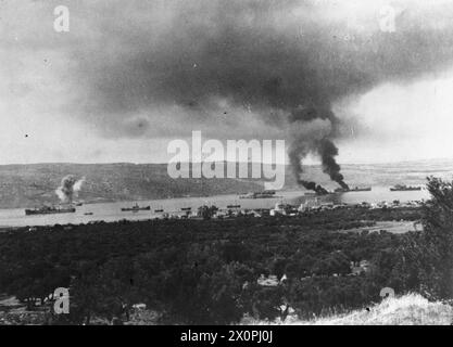 THE BATTLE FOR CRETE, 20 - 31 MAY 1941 - A pall of smoke hanging over the habour in Suda Bay where two ships, hit by German bombers, are burning, 25 June 1941 Stock Photo