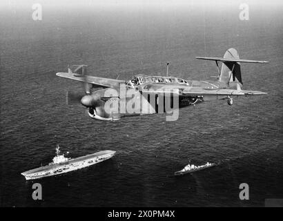 THE ROYAL NAVY DURING THE SECOND WORLD WAR - A Fairey Barracuda II of 814 Squadron, Fleet Air Arm flying over HMS VENERABLE and an attendant destroyer, the Italian ALFREDO ORIANI Royal Navy, Fleet Air Arm, 814 Naval Air Squadron, Royal Navy, HMS Vengeance, Light Fleet Carrier, (1944), Italian Navy, ALFREDO ORIANI (RN) Stock Photo