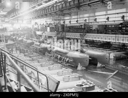 BRITISH NAVY TAKES OVER AT KIEL. 12 MAY 1945, KIEL. THE ROYAL NAVY TRAVELLING OVERLAND FROM OSTEN TOOK OVER THE GERMAN NAVAL PORT AND DOCKYARD AT THE SOUTHERN END OF KIEL BAY. - General view in a gigantic shelter where 2-men midget U-boats arrived in sections and were assembled Stock Photo