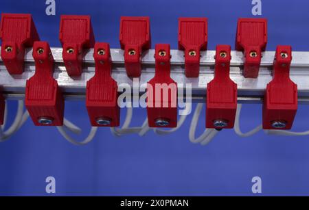 Red wire contacts on a blue background. Installation electrical cables. Stock Photo