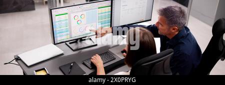 Medical coder working on multiple computer spreadsheets Stock Photo