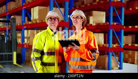 Osha Inspection Using Tablet. Inspecting Warehouse Inventory Stock Photo