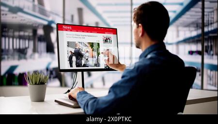 Man Reading News Website On Computer Screen Stock Photo