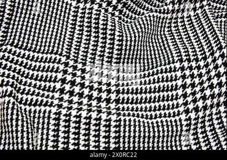 Winter cashmere scarf. Black and white cage texture fabric. Textile warm dark knitted cloth background. Stock Photo