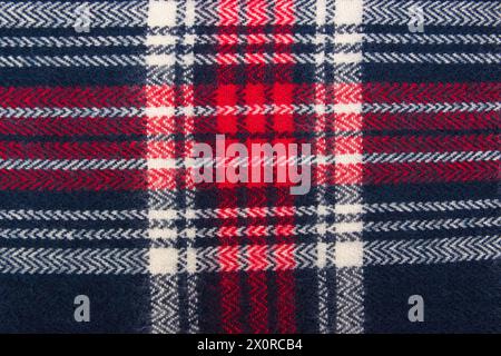 Winter cashmere scarf. Blue, white, red cage texture fabric. Textile warm dark knitted cloth background. Stock Photo