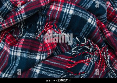 Winter cashmere scarf. Blue, white, red cage texture fabric. Textile warm dark knitted cloth background. Stock Photo