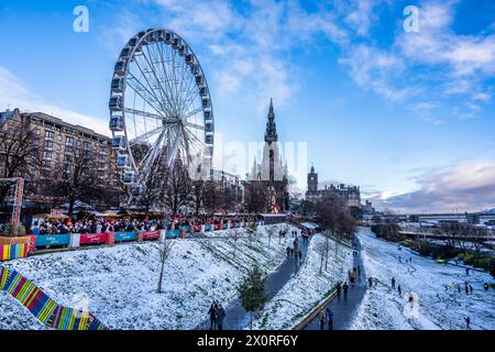Christmas 2022 - The Big Wheel and Edinburgh Christmas Market in East Princes Street Gardens, with Scott Monument beyond, in Edinburgh, Scotland, UK Stock Photo
