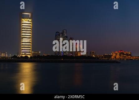 A picture of the Etihad Towers, the Abu Dhabi National Oil Company Headquarters and the Emirates Palace Mandarin Oriental Hotel at night. Stock Photo