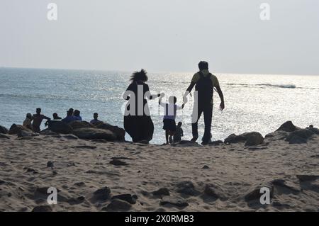 Dhanushkodi ,Tamil Nadu India-Feb11th 2024 Happy Indian family,father mother and son holding hands running down to seashore at dhanushkodi with happy Stock Photo