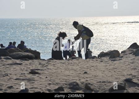 Dhanushkodi ,Tamil Nadu India-Feb11th 2024 Happy Indian family,father mother and son holding hands running down to seashore at dhanushkodi with happy Stock Photo