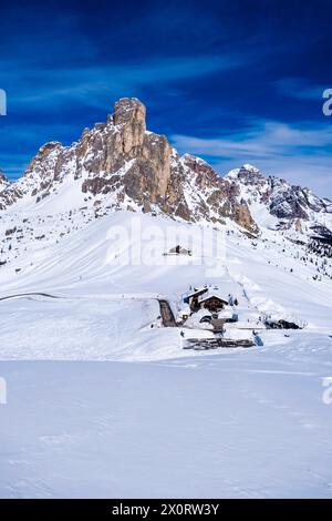 Aerial view on the snow-covered Giau pass with the Hotel Passo Giau in winter, the summit of Ra Gusela in the distance. Cortina dAmpezzo Veneto Italy Stock Photo