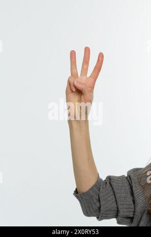 Pointing up with fingers number three. Close up, isolated on white background. Stock Photo