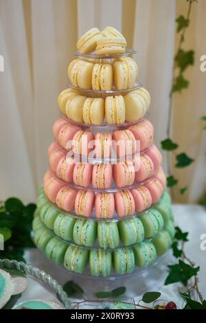 Macaron tower or pyramid and cupcakes on sweet dessert table Stock Photo