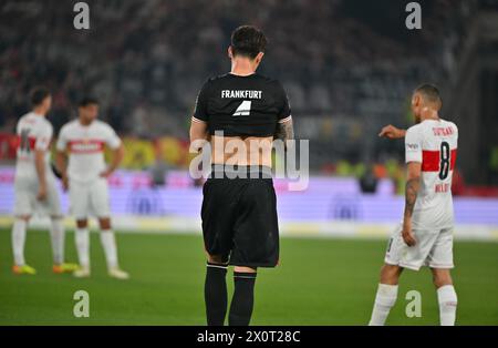 13 April 2024, Baden-Württemberg, Stuttgart: Soccer: Bundesliga, VfB Stuttgart - Eintracht Frankfurt, Matchday 29, MHPArena. Robin Koch from Eintracht Frankfurt pulls up his jersey at the end of the match. The Stuttgart players cheer in the background. The game ended 3:0. Photo: Jan-Philipp Strobel/dpa - IMPORTANT NOTE: In accordance with the regulations of the DFL German Football League and the DFB German Football Association, it is prohibited to utilize or have utilized photographs taken in the stadium and/or of the match in the form of sequential images and/or video-like photo series. Stock Photo