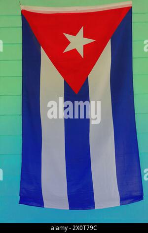 169 Cuban flag on the light-green wall of a porch in a bohio -Cuban hut- of the Valle de Viñales Valley. Pinar del Rio province-Cuba. Stock Photo