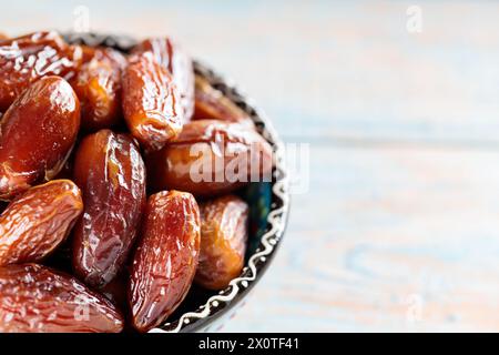 Dried Dates in Bowl on Wooden Boards, Copy Space Stock Photo