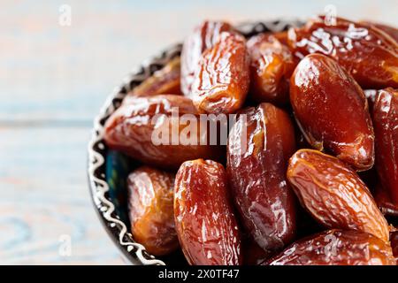 Dried Dates in Bowl on Wooden Boards, Copy Space Stock Photo