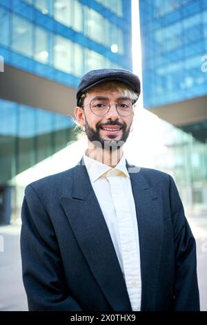 Young adult Caucasian business man in formal urban style looking confident at camera. Stock Photo