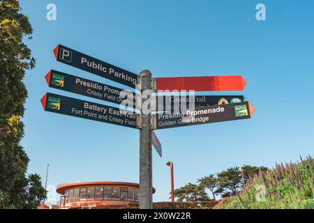 San Francisco, California, April 9, 2024.  Directional signpost with multiple arrows pointing to various landmarks near the Golden Gate Bridge. Stock Photo