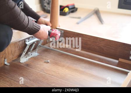 using electric drilling on wooden table  Stock Photo
