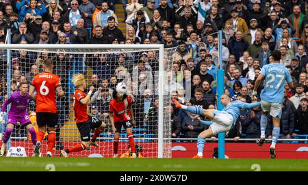 (240414) -- MANCHESTER, April 14, 2024 (Xinhua) -- Manchester City's Erling Haaland (2nd R) shoots during the English Premier League match between Manchester City and Luton Town in Manchester, Britain, April 13, 2024. (Xinhua) FOR EDITORIAL USE ONLY. NOT FOR SALE FOR MARKETING OR ADVERTISING CAMPAIGNS. NO USE WITH UNAUTHORIZED AUDIO, VIDEO, DATA, FIXTURE LISTS, CLUB/LEAGUE LOGOS OR 'LIVE' SERVICES. ONLINE IN-MATCH USE LIMITED TO 45 IMAGES, NO VIDEO EMULATION. NO USE IN BETTING, GAMES OR SINGLE CLUB/LEAGUE/PLAYER PUBLICATIONS. Stock Photo