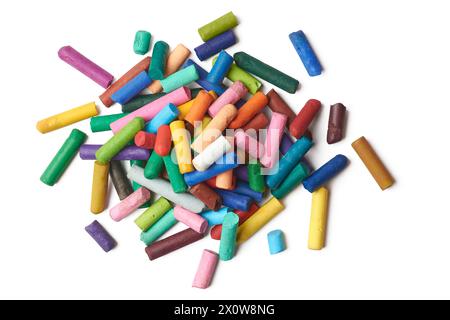 multicolor used oil pastel crayons, pile of old half used wax crayon pieces isolated white background, scattered taken from above Stock Photo