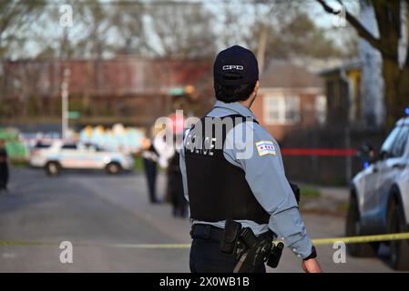 Police officers from the Chicago Police Department rush to the scene of a 20-year-old male who was fatally shot. At approximately 5:19 p.m. Saturday in the 7700 block of S. Union, a 20-year-old male victim was standing on the sidewalk when two unknown male suspects fired multiple gunshots in the victim's direction from down the street. The victim sustained one gunshot wound to the lower back, the suspects fled on foot and got into a Silver vehicle before fleeing the scene. The victim was transported to The University of Chicago Hospital and was pronounced dead at the hospital. There are no sus Stock Photo