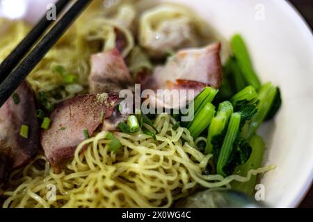 Egg noodle with wonton and red roasted pork. Asian food style. Stock Photo