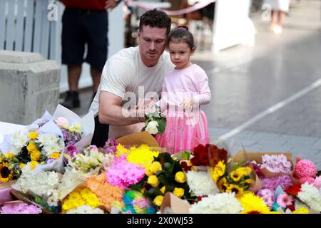 Sydney, Australia. 14th Apr, 2024. People lay flowers outside the Westfield Shopping Centre at Bondi Junction in Sydney, Australia, April 14, 2024. Australian police on Sunday identified the perpetrator of a Sydney shopping centre stabbing that killed six people, saying no intelligence would suggest the attack was driven by ideology. The offender in the Saturday afternoon attack at Westfield Shopping Centre at Bondi Junction was 40-year-old Joel Cauchi from Queensland, New South Wales (NSW) Police Assistant Commissioner Anthony Cooke told reporters. Credit: Ma Ping/Xinhua/Alamy Live News Stock Photo