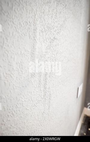 grey painted woodchip wallpaper texture pattern backgroung. Stock Photo