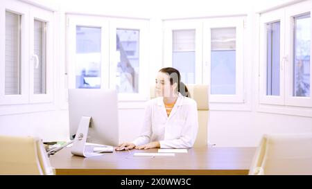 Female doctor in the office using computer Stock Photo
