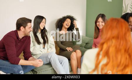 Diverse group of people laughing sitting on the sofa Stock Photo