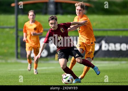 Andrea Di Benedetto (11) of Belgium and Sil Blokhuis (17) of The Netherlands pictured during a friendly soccer game between the national under 16 Futures teams of The Netherlands and Belgium on  Saturday 13 April 2024  in Tubize , Belgium . PHOTO SPORTPIX | David Catry Stock Photo