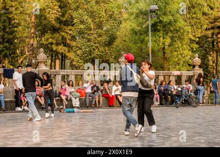People dancing at Alameda Central, a beautiful urban park. Alameda central in Mexico city is a historic urban park that dates back to the 16th century, making it one of the oldest public parks in the Americas. with its lush greenery, ornate fountains, and statues, it offers a serene oasis in the heart of the bustling metropolis, attracting locals and tourists alike for leisurely strolls and relaxation. Stock Photo
