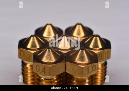 3D printer brass nozzle. Macro of different printer nozzle sizes. Threaded brass nozzles. Parts for 3D printer Stock Photo