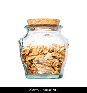Walnut kernel halves, in glass jar isolated on white background. Shelled, dried seeds of the common walnut tree Juglans regia, used as snack or for ba Stock Photo