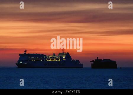 A sunrise view of the Brittany Ferries' cross-Channel ferry Mont St. Michel as she passes Spitbank Fort on the approach to Portsmouth Harbour. Stock Photo