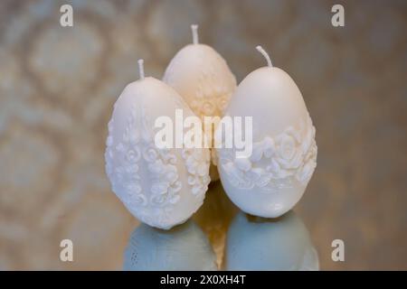 White easter egg soy wax candles. Mirror background Stock Photo