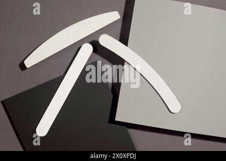 Set of gray nail files of different shapes and different stiffness on dark grey background, isometric. Tools for manicure Stock Photo