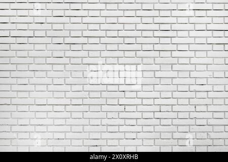 Background of worn white brick wall, urban patterns and textures Stock Photo