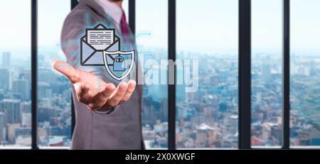 cybersecurity and data protection concept. executive holds hologram of envelope with shield and padlock. Stock Photo