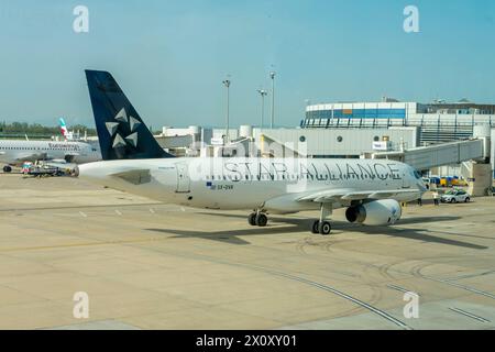 Aerial view of the airport terminal, tower and apron with Star Alliance aircraft; Austria, Vienna, April 09, 2024. Stock Photo